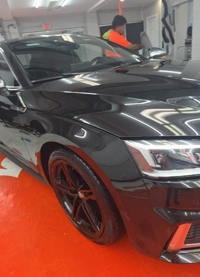 Glossy black Audi S5 front quarter panel after detailing in the shop