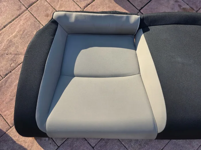 Clean light cloth rear car seat after hot water extraction during an interior detail