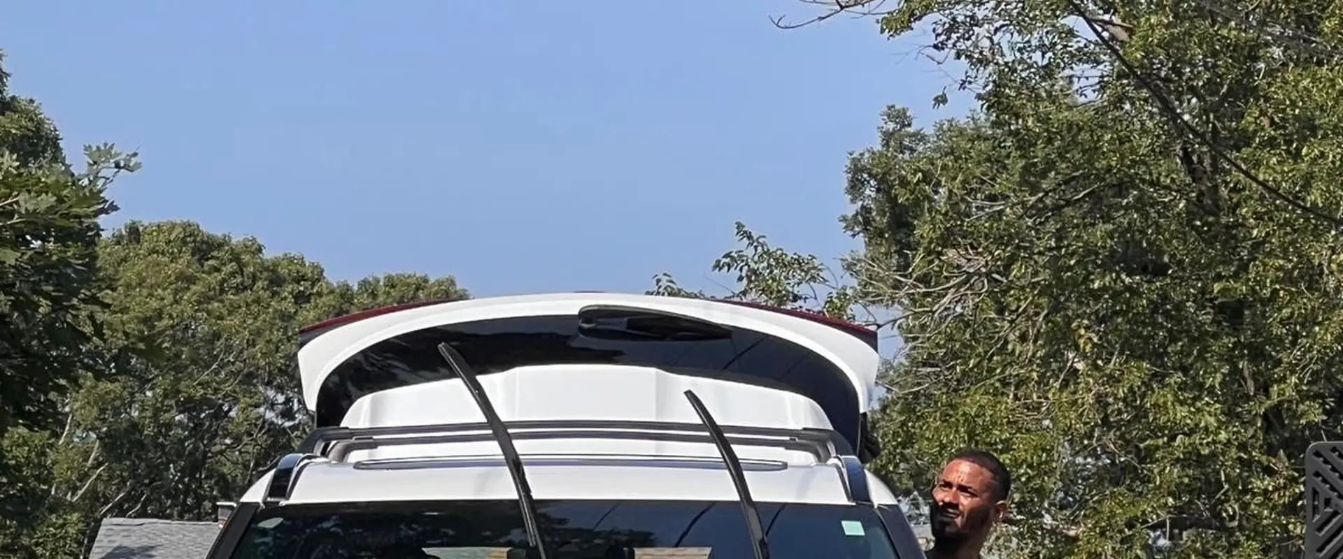 Mobile detailing van parked beside a large pickup truck for an exterior wash