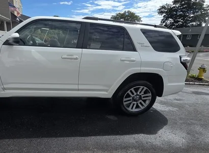Clean wheel and tire on a white Toyota 4Runner after a hand wash